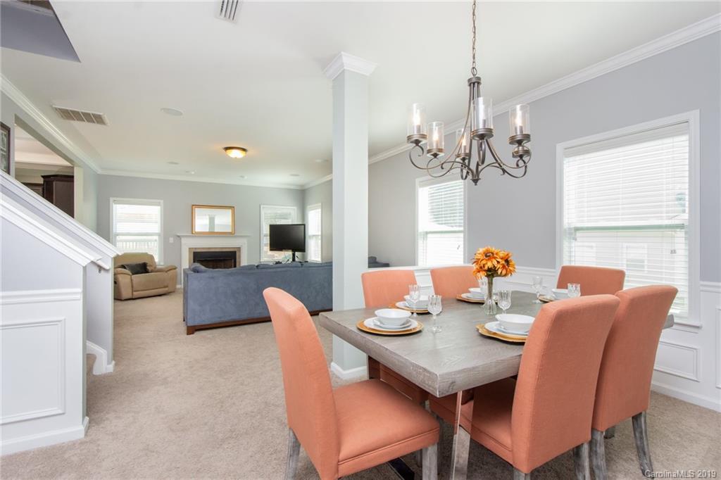 7059 Meyer Road Fort Mill, SC 29715 - Photo 6 of 30 a view of a dining room with furniture wooden floor and chandelier