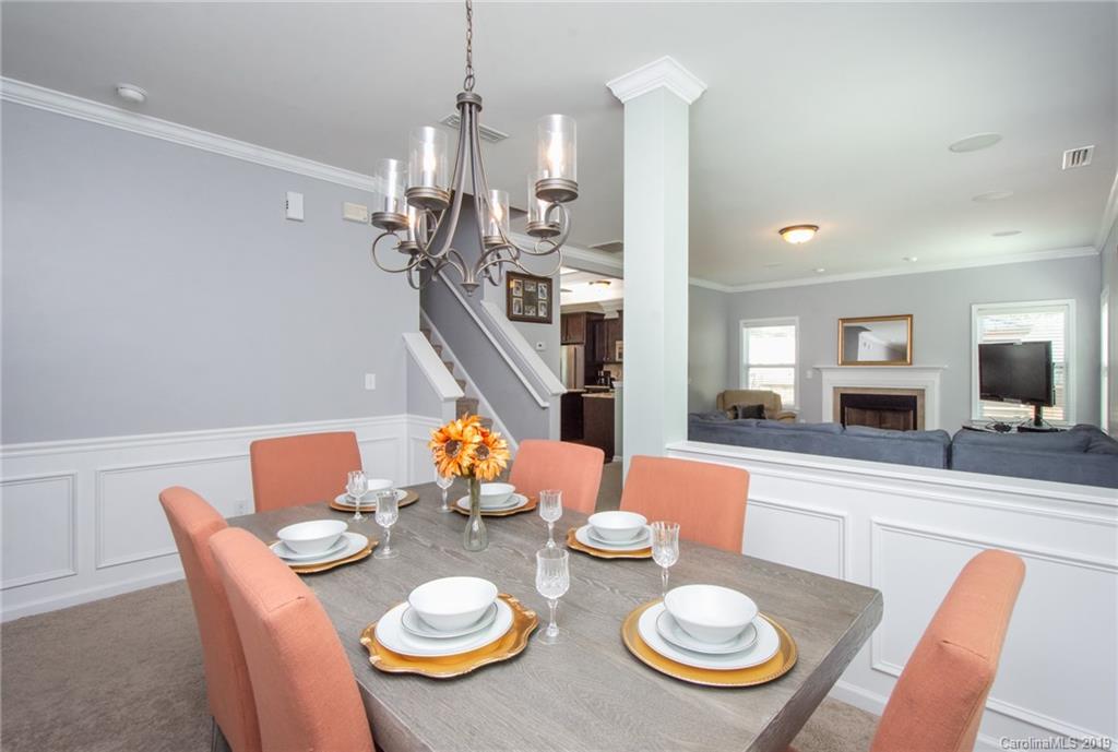 7059 Meyer Road Fort Mill, SC 29715 - Photo 7 of 30 a view of a dining room with furniture a chandelier and wooden floor