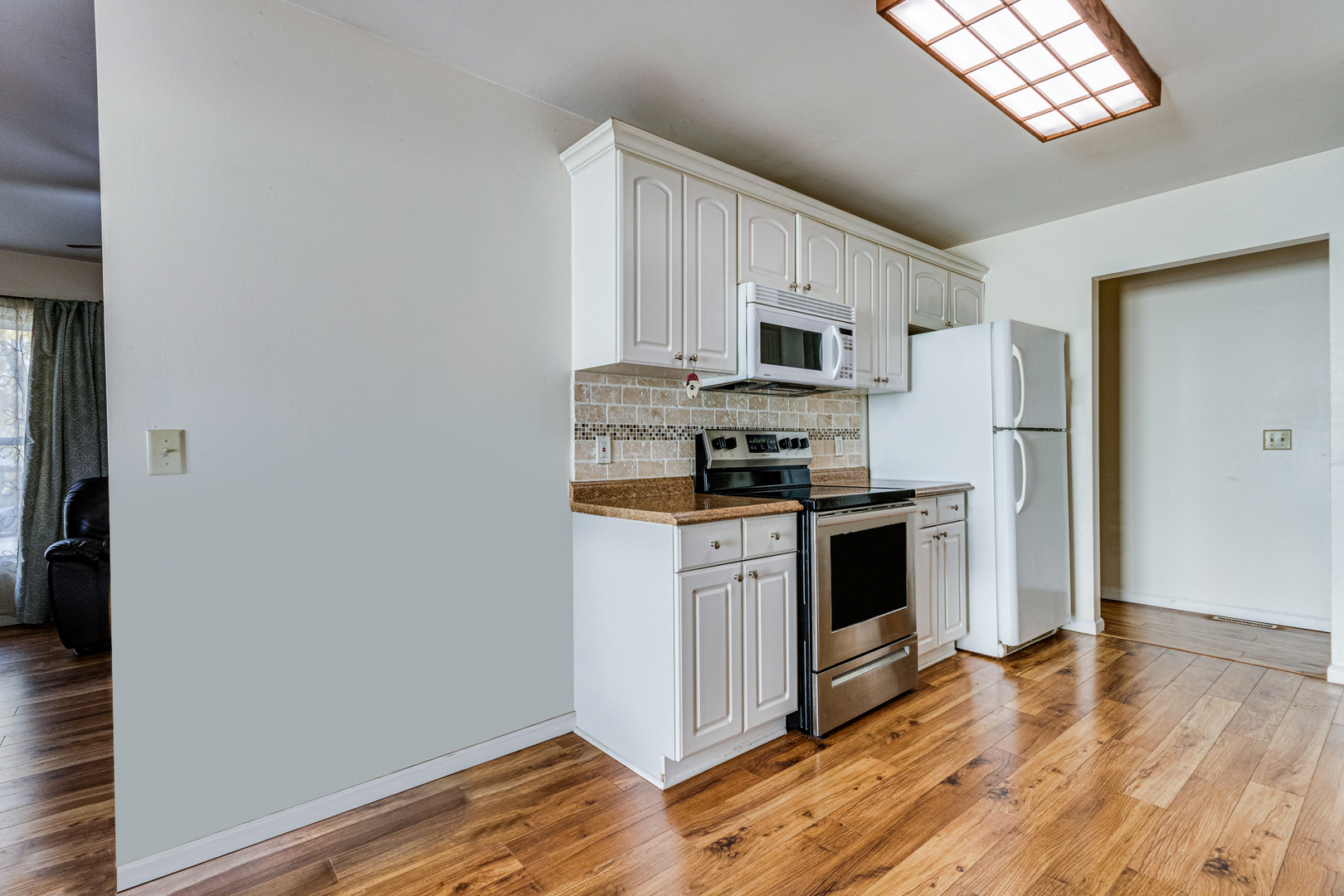 12 Roulock Road Montgomery, IL 60538 - Photo 6 of 17 a kitchen with stainless steel appliances a stove a sink and a refrigerator