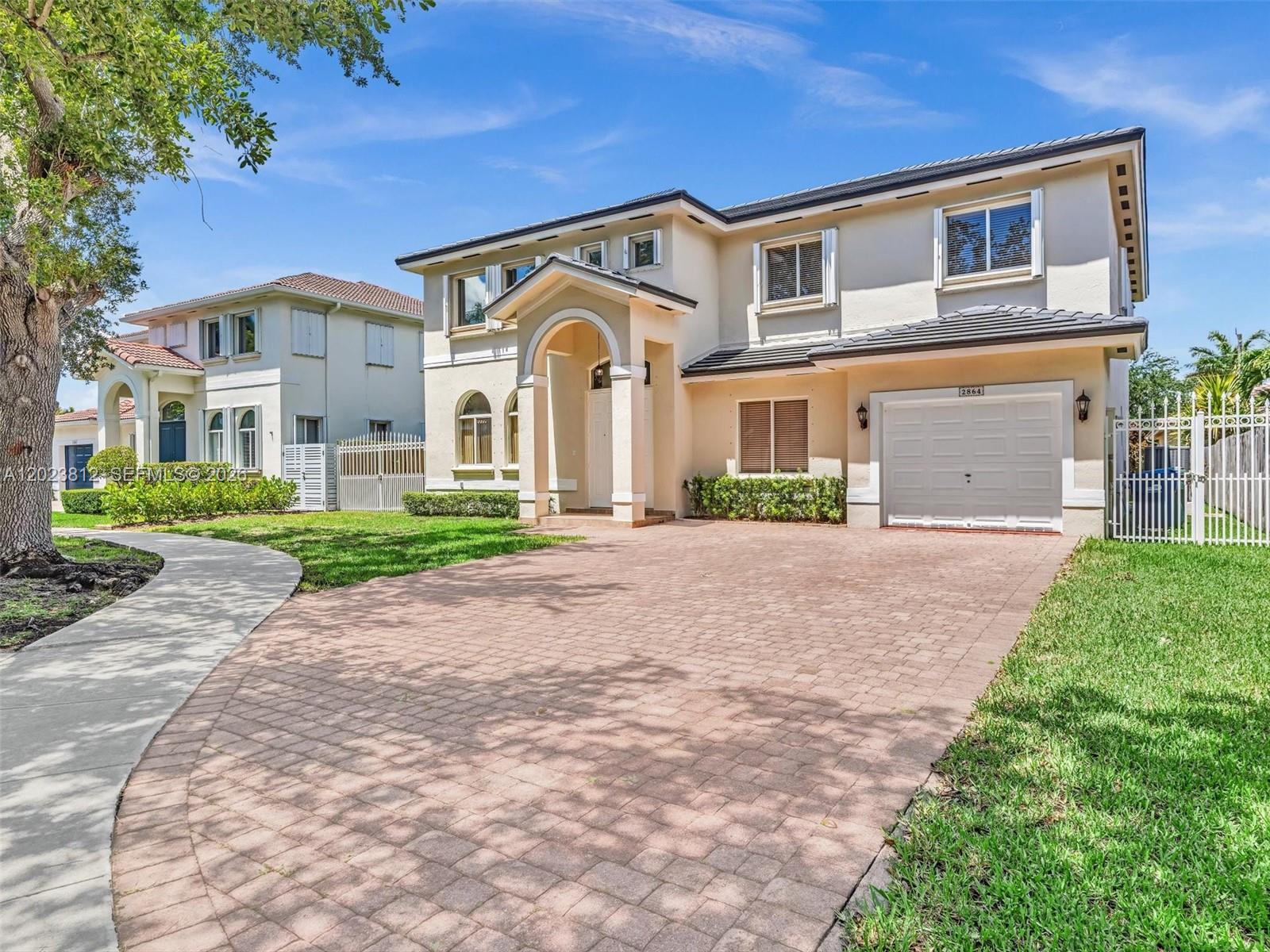 2864 Southwest 138th Path Miami, FL 33175 - Photo 1 of 40 a front view of a house with a yard and garage
