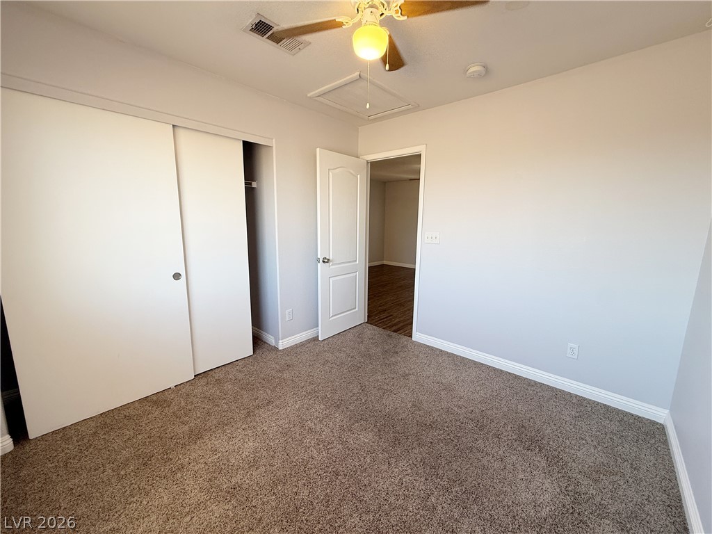 2185 Polynesia Circle Henderson, NV 89074 - Photo 27 of 37 A comfortable bedroom features plush carpeting and a convenient sliding closet.