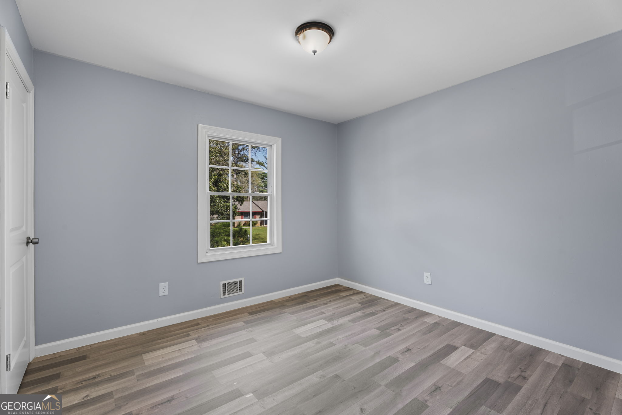 1685 Kinglet Road Jonesboro, GA 30238 - Photo 14 of 34 wooden floor in an empty room with a window
