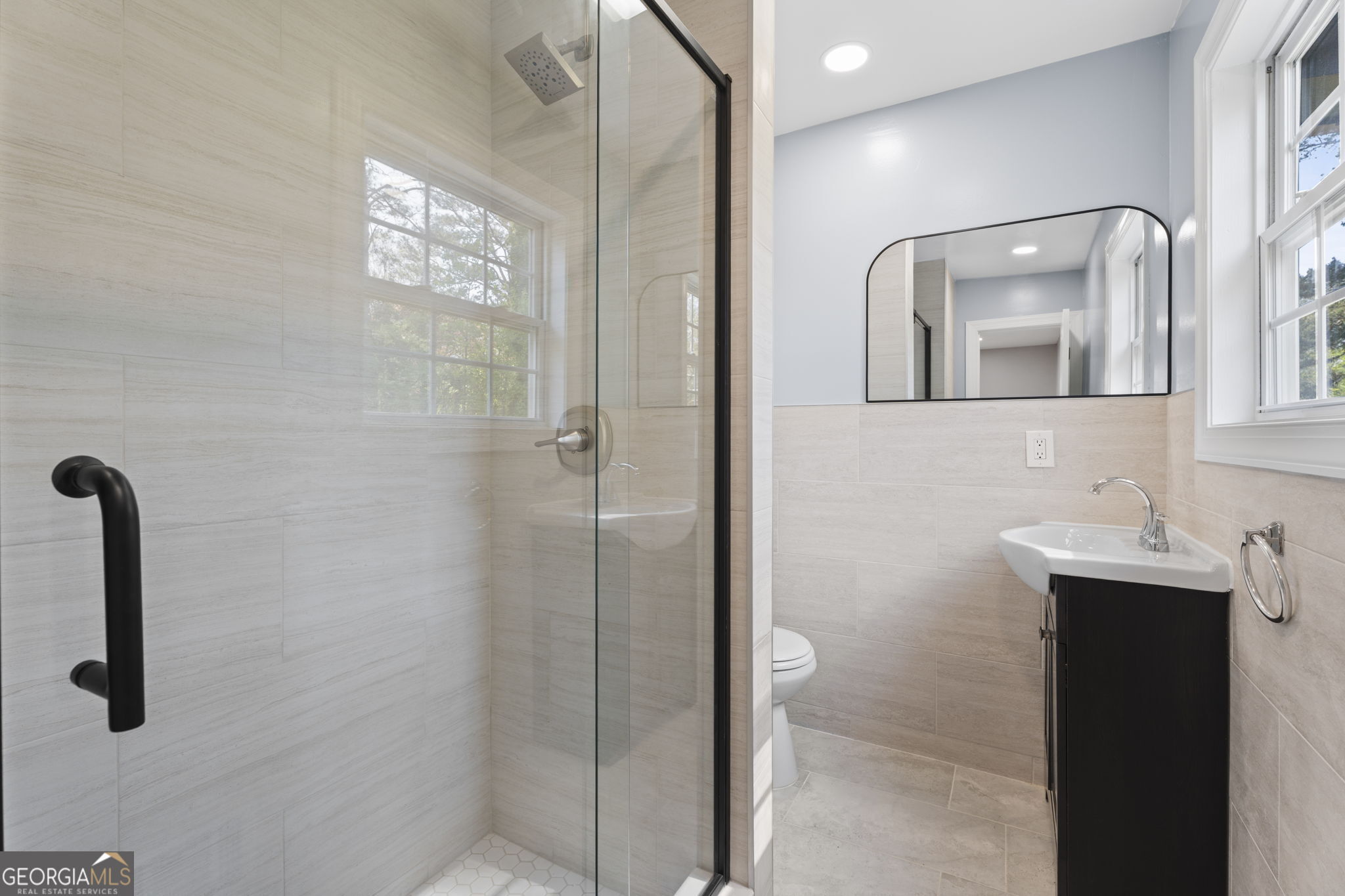 1685 Kinglet Road Jonesboro, GA 30238 - Photo 21 of 34 a bathroom with a sink a mirror a vanity and shower