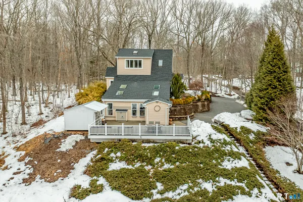 a view of a chairs and table in backyard