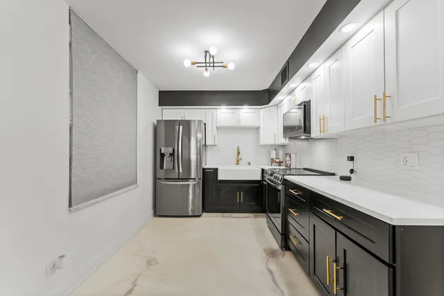 a kitchen with kitchen island a sink stainless steel appliances and cabinets