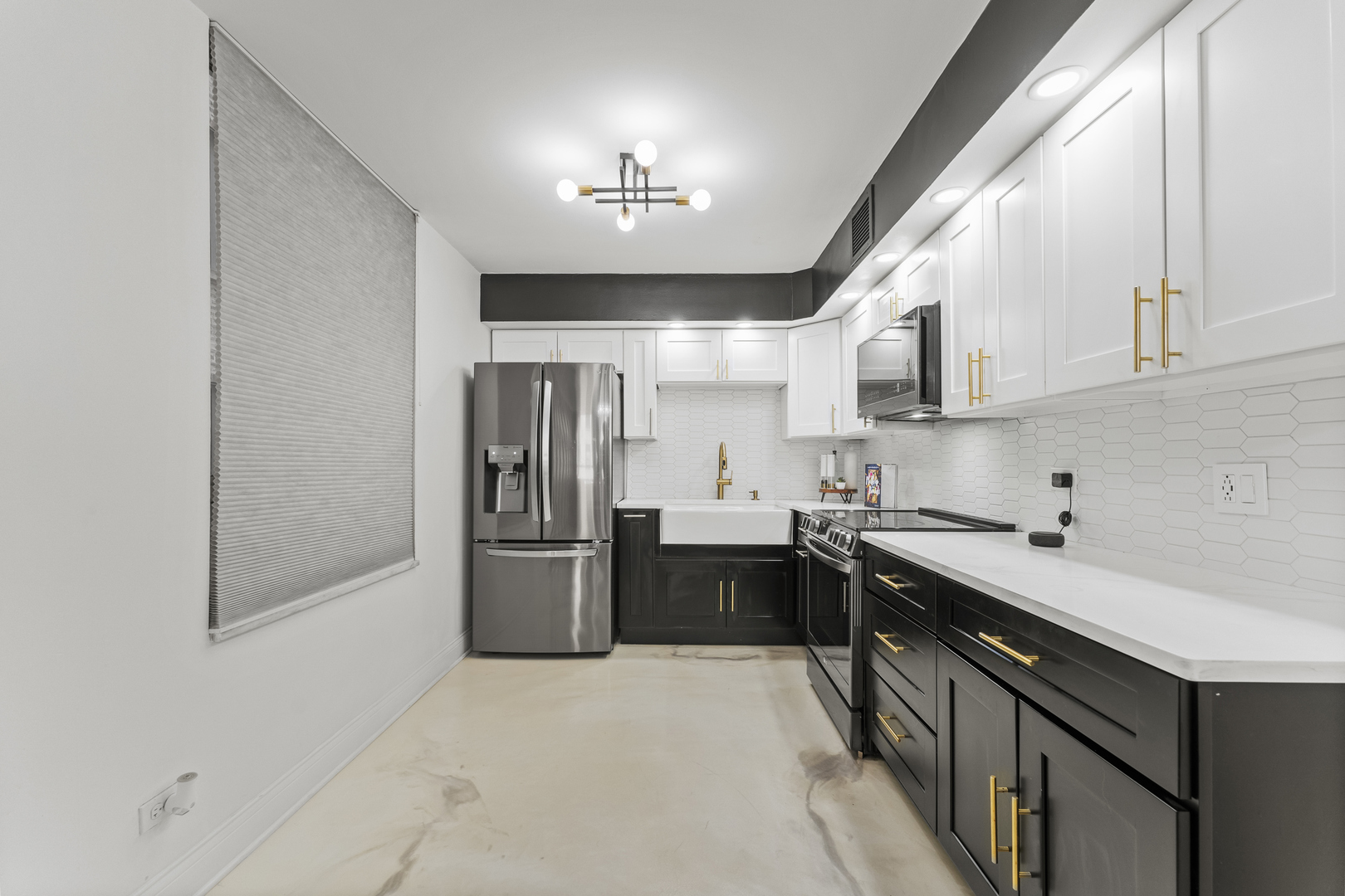 201 East Chestnut Street, Unit 11E Chicago, IL 60611 - Photo 12 of 43 a kitchen with a sink stainless steel appliances cabinets and a window