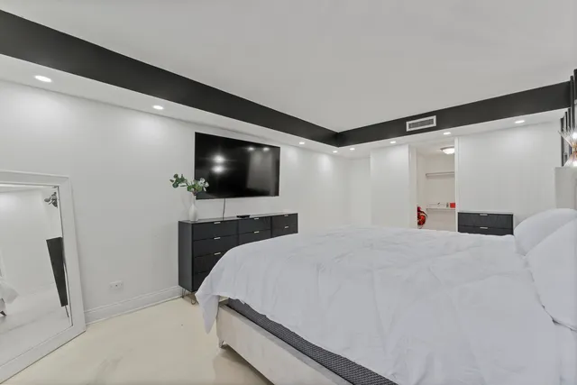 a large white bed in a white room