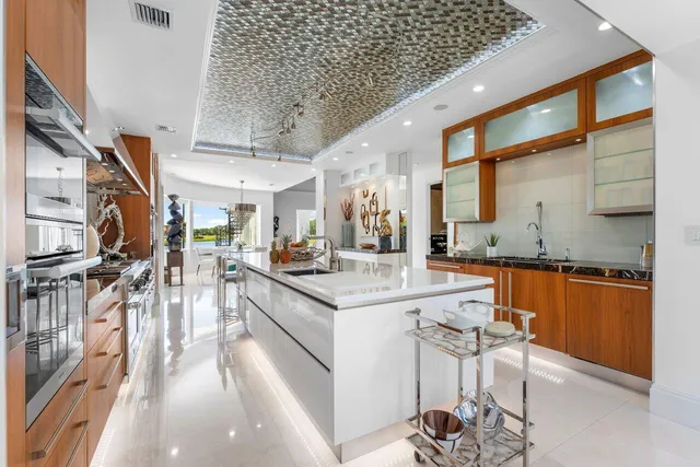 a kitchen with stainless steel appliances granite countertop a refrigerator and a sink