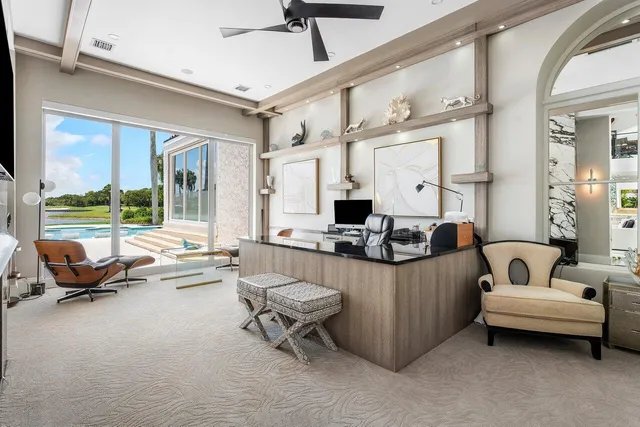 a living room with furniture and large windows