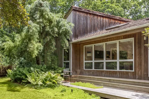 a view of a house with a large window and yard