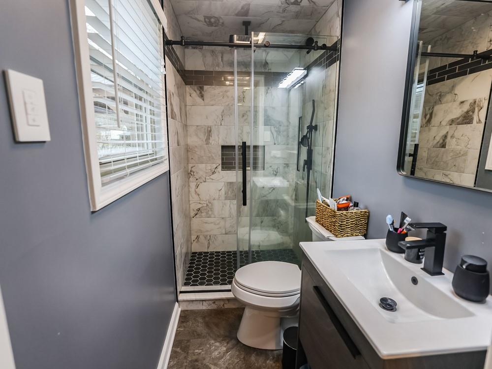 136 Ridgewood Drive Economy, PA 15042 - Photo 11 of 17 a bathroom with a sink toilet and shower