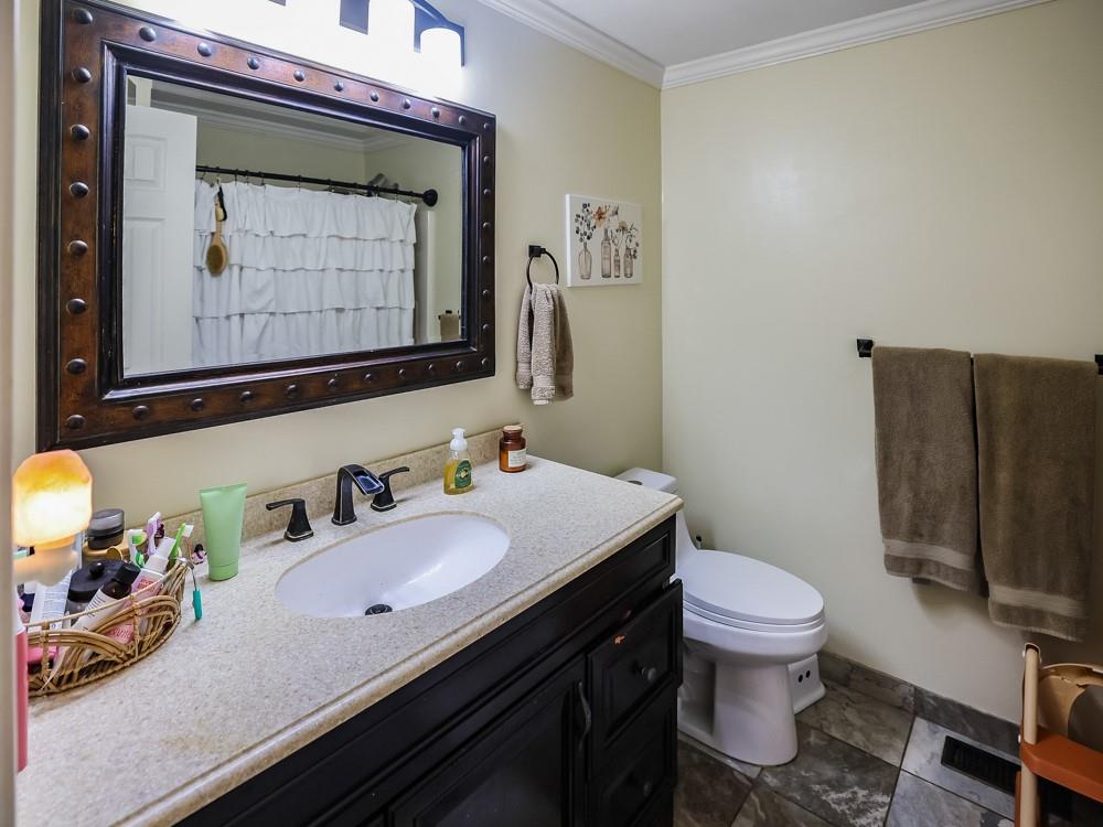 136 Ridgewood Drive Economy, PA 15042 - Photo 13 of 17 a bathroom with a sink a toilet and mirror