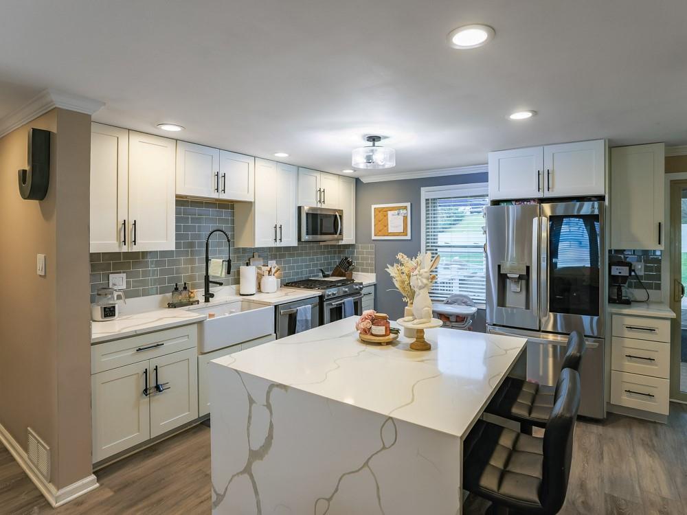 136 Ridgewood Drive Economy, PA 15042 - Photo 3 of 17 a kitchen with a sink a stove a refrigerator cabinets and wooden floor