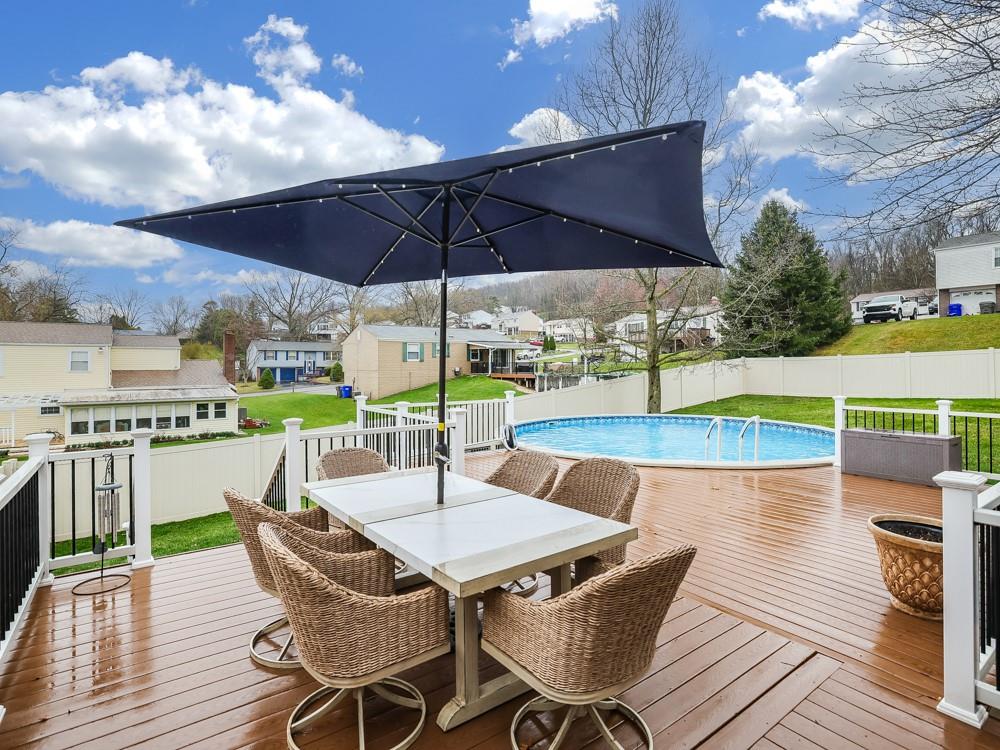 136 Ridgewood Drive Economy, PA 15042 - Photo 8 of 17 a view of an outdoor sitting area with furniture and umbrella