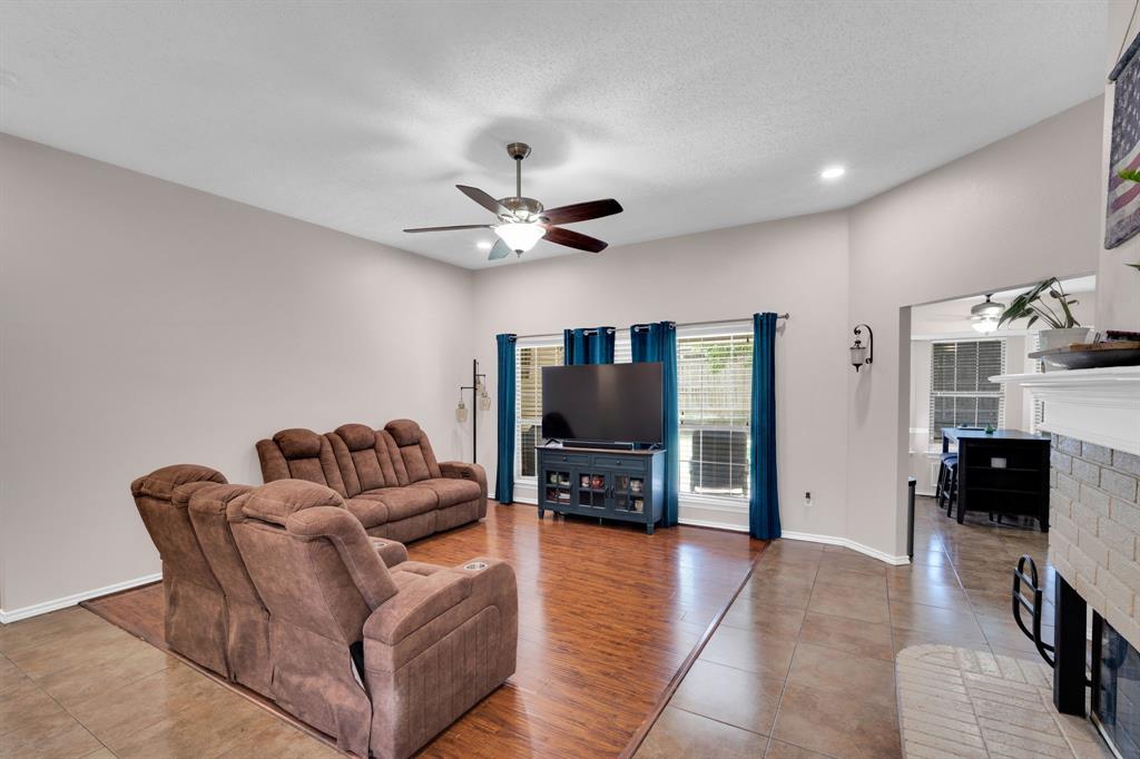 1001 Short Line Boulevard Midlothian, TX 76065 - Photo 20 of 26 Spacious living area featuring ceiling fan, recessed lighting, and a fireplace with a light-colored brick surround