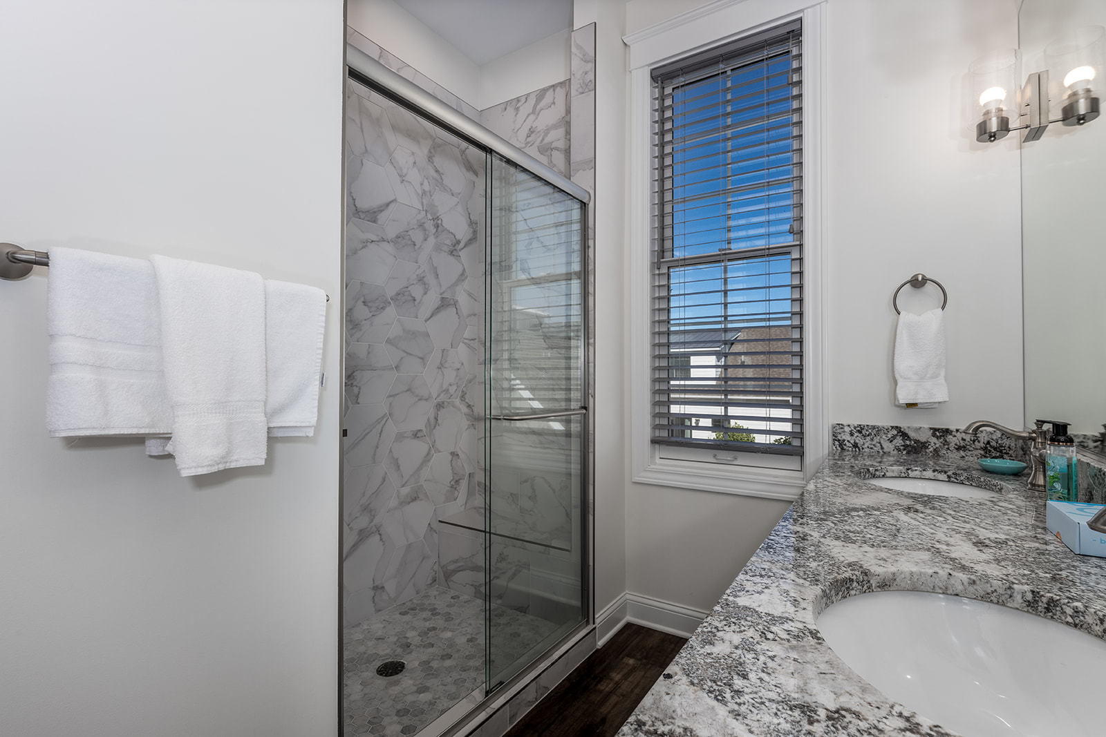 8 Port Place Ottawa, IL 61350 - Photo 22 of 32 a bathroom with a granite countertop sink a mirror and shower