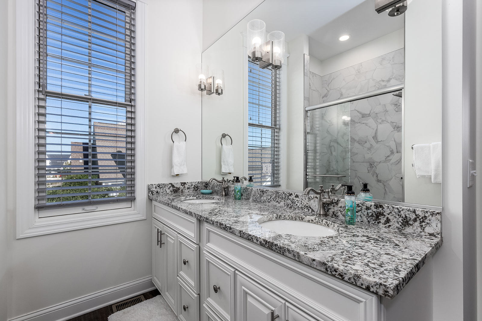 8 Port Place Ottawa, IL 61350 - Photo 23 of 32 a bathroom with a granite countertop sink and a mirror
