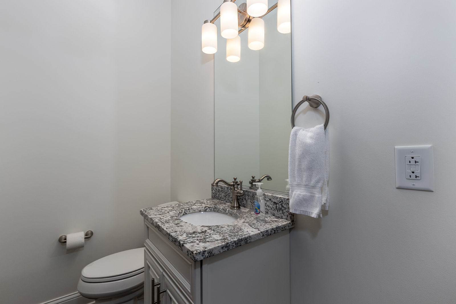 8 Port Place Ottawa, IL 61350 - Photo 26 of 32 a bathroom with a granite countertop sink a toilet and a mirror