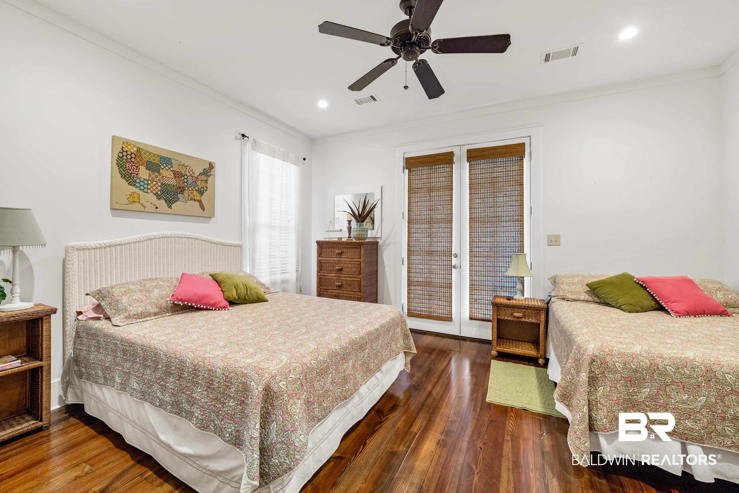 25773 Canal Road, Unit 10 Orange Beach, AL 36561 - Photo 22 of 40 Bedroom with access to exterior, ceiling fan, french doors, beautiful hardwood floor, and crown molding