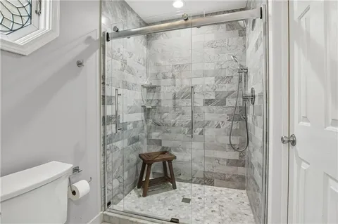 a en suite bathroom with a granite countertop sink and a mirror