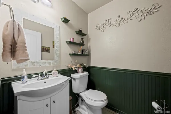 a bathroom with a sink toilet and mirror