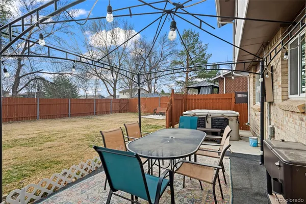 a backyard of a house with table and chairs