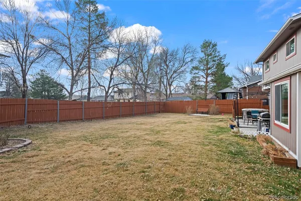 a backyard of a house with table and chairs