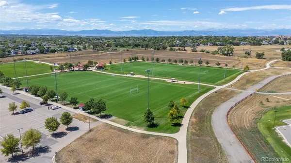 an aerial view of a golf course with parking space