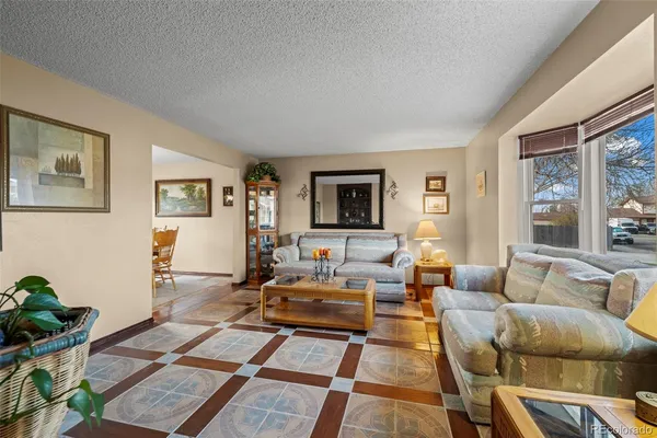 a living room with furniture wooden floor and window