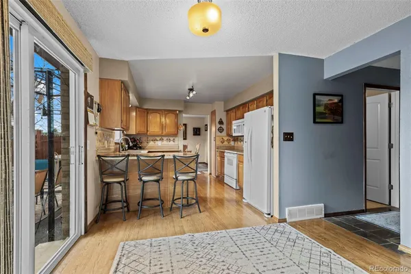 a living room with stainless steel appliances furniture fireplace and rug