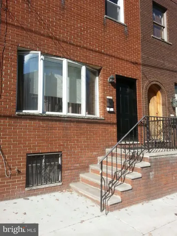 a view of a brick house with large windows