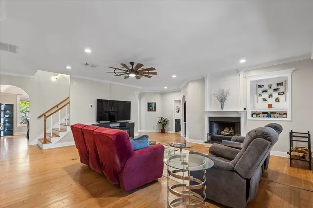 a living room with furniture a fireplace and a flat screen tv