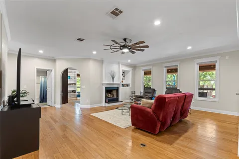 a living room with furniture and a wooden floor