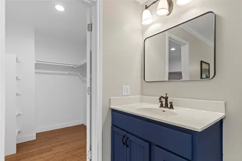 a bathroom with a sink vanity and mirror