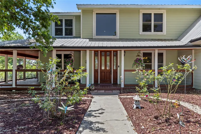 a front view of a house with garden