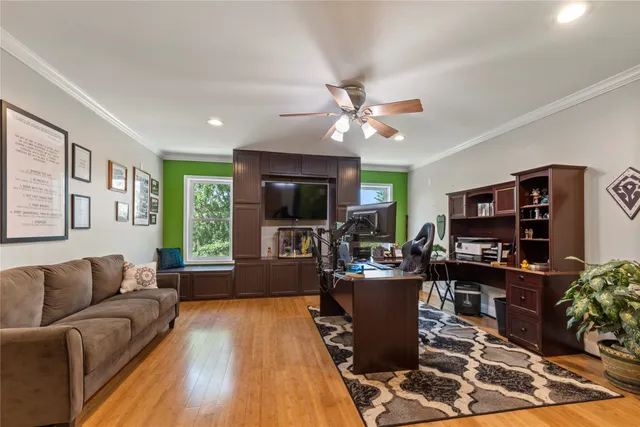 a living room with furniture and a flat screen tv
