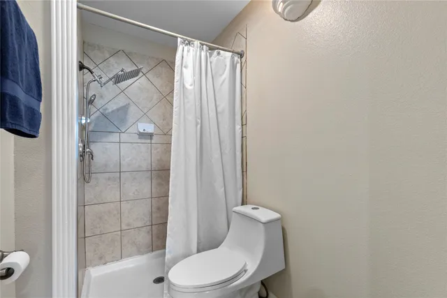 a white toilet sitting next to a bathroom sink