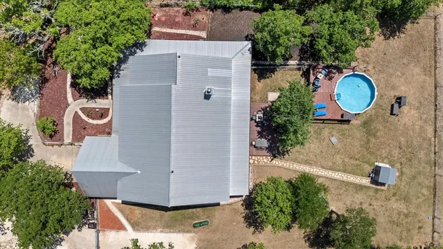 an aerial view of a house with a yard