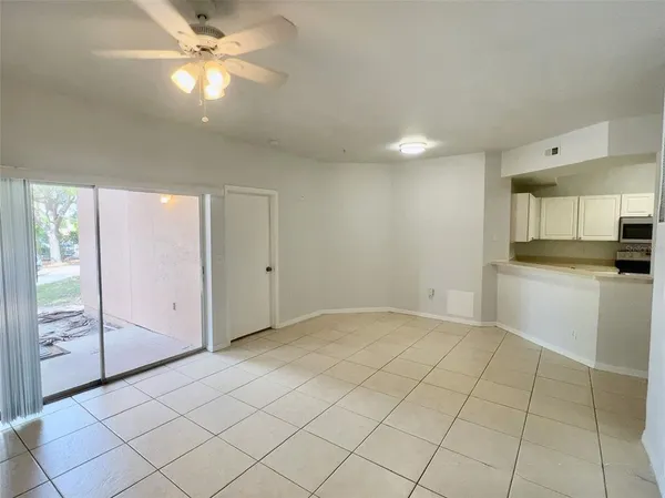 a view of a kitchen with an empty space and a window