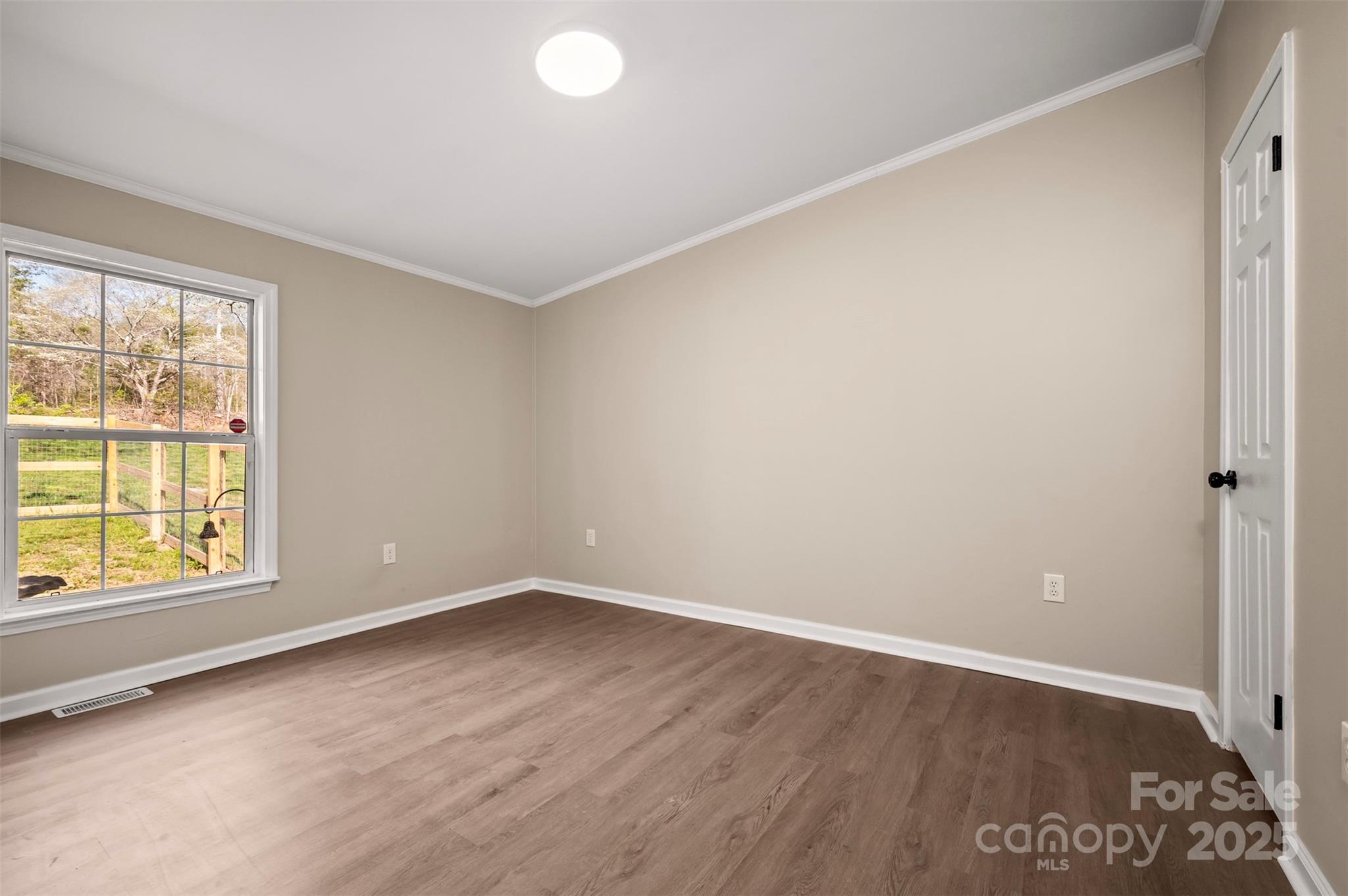 3114 Bostic Sunshine Highway Bostic, NC 28018 - Photo 11 of 48 an empty room with wooden floor and windows
