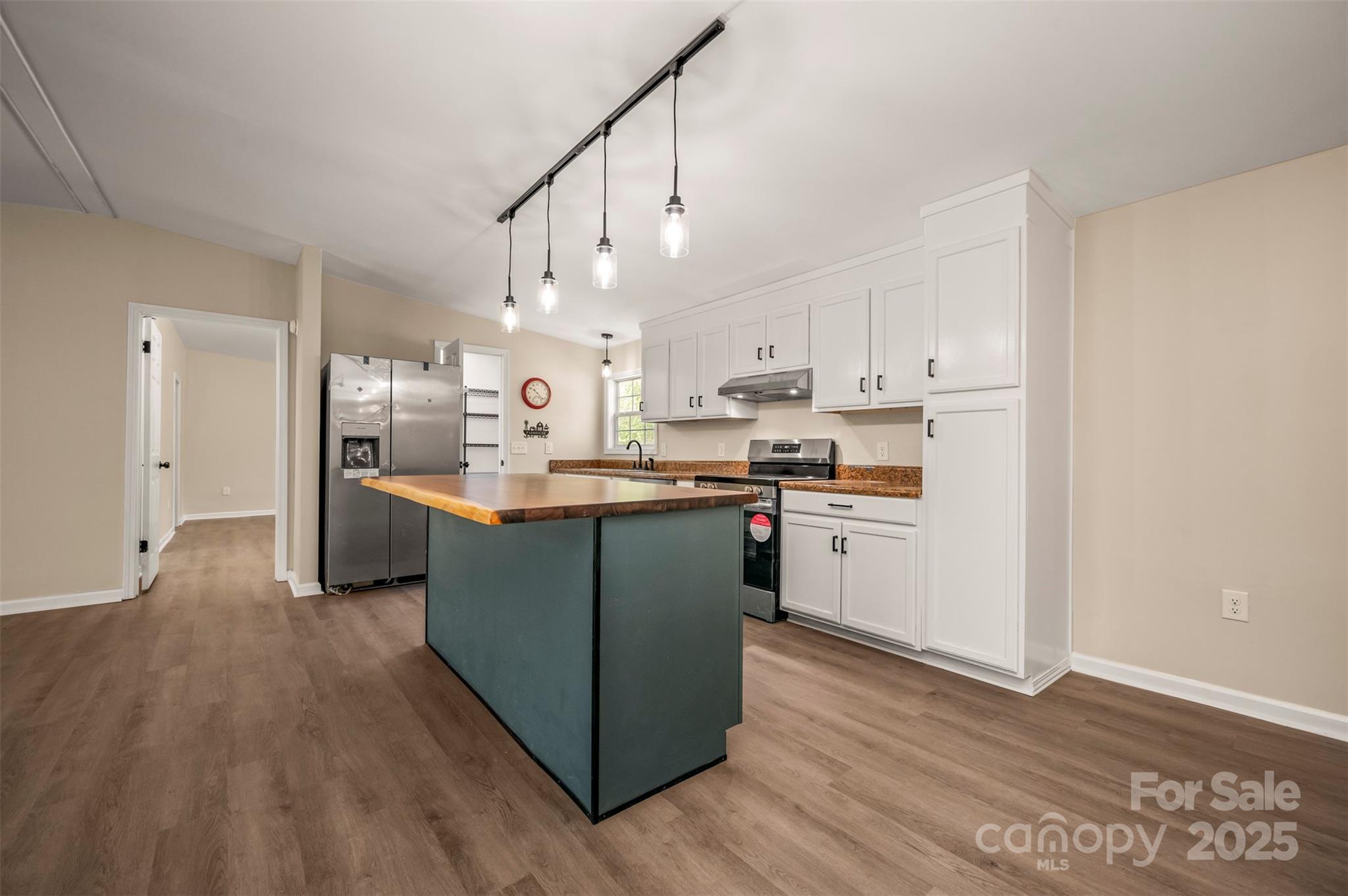 3114 Bostic Sunshine Highway Bostic, NC 28018 - Photo 22 of 48 a kitchen with stainless steel appliances granite countertop a refrigerator a sink dishwasher a stove and white cabinets with wooden floor