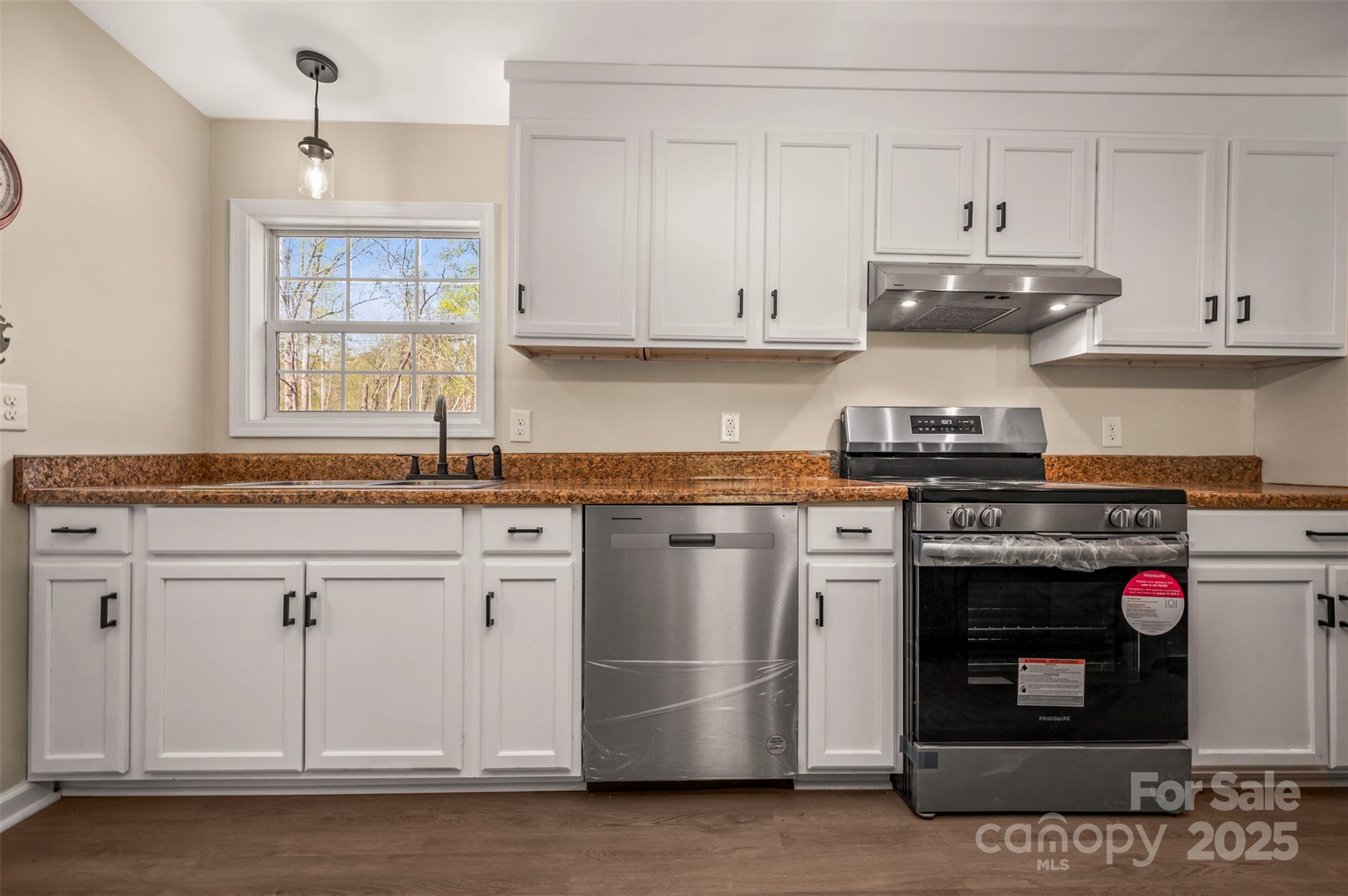 3114 Bostic Sunshine Highway Bostic, NC 28018 - Photo 24 of 48 a kitchen with stainless steel appliances granite countertop a stove a sink and a white cabinets