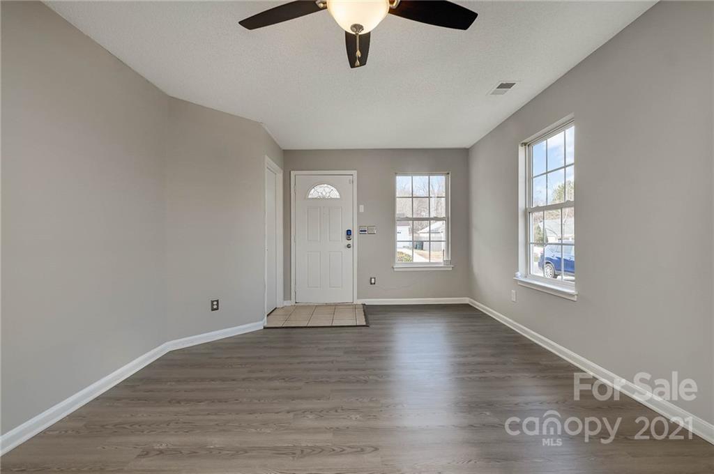 2884 Rockingham Court Southwest Concord, NC 28025 - Photo 11 of 17 wooden floor in an empty room with a window