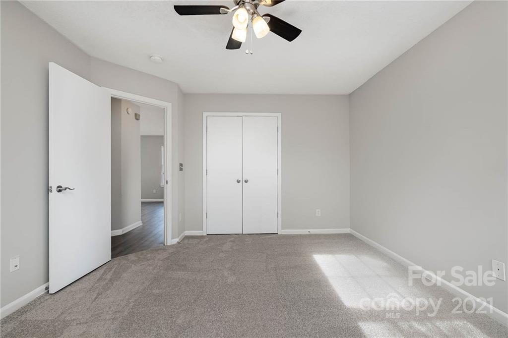 2884 Rockingham Court Southwest Concord, NC 28025 - Photo 12 of 17 a view of a livingroom with a ceiling fan & kitchen space