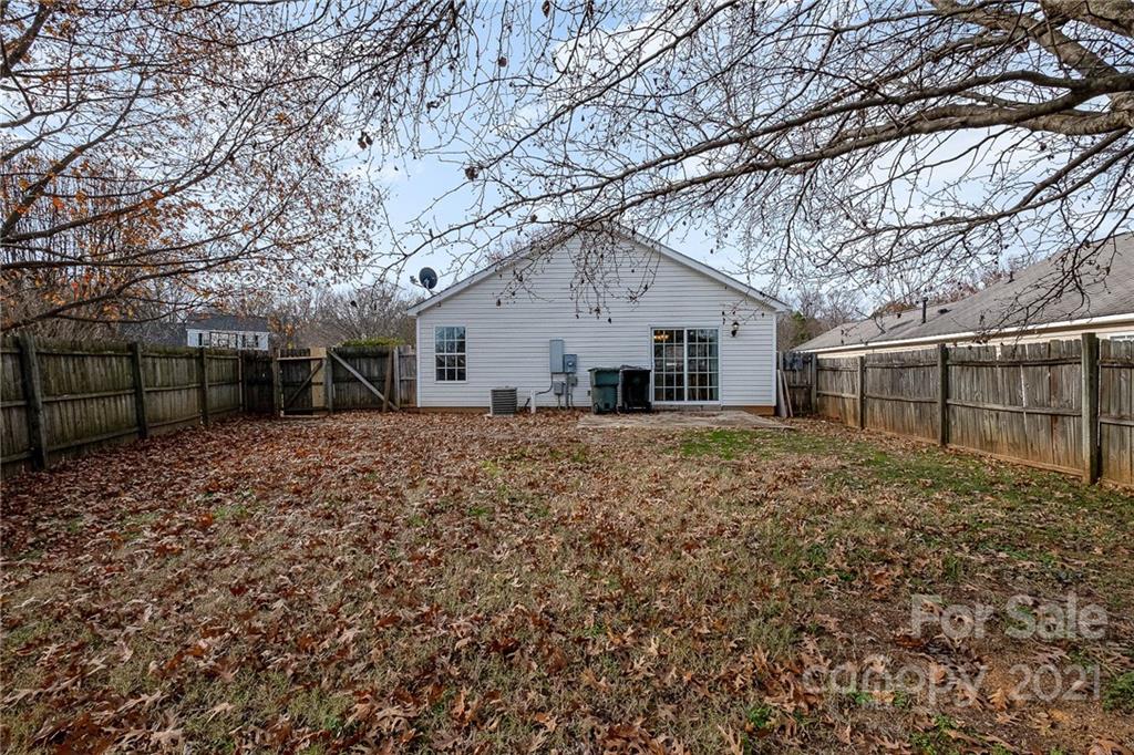 2884 Rockingham Court Southwest Concord, NC 28025 - Photo 17 of 17 a view of a yard with a house and a large tree