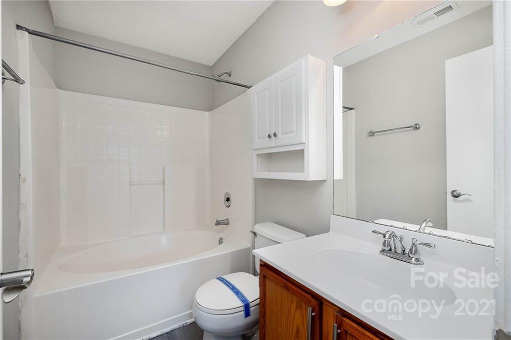 2884 Rockingham Court Southwest Concord, NC 28025 - Photo 6 of 17 a bathroom with a sink toilet vanity and shower