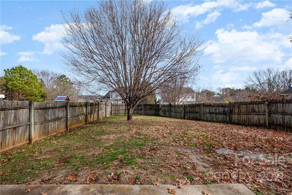 2884 Rockingham Court Southwest Concord, NC 28025 - Photo 7 of 17 a view of a backyard with wooden fence