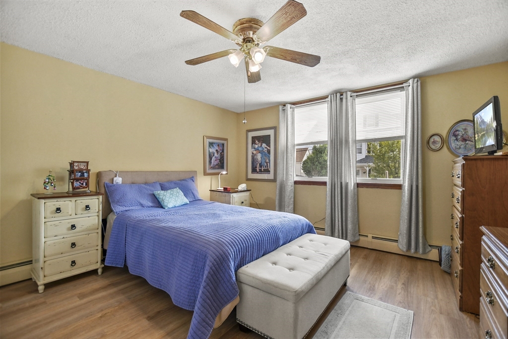 82 Cedar Street Everett, MA 02149 - Photo 12 of 41 a bedroom with a bed and a tv