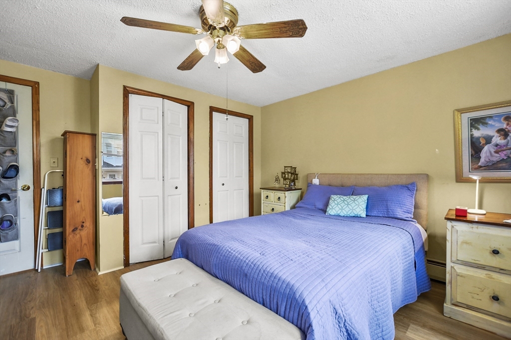 82 Cedar Street Everett, MA 02149 - Photo 14 of 41 a bedroom with a large bed and a chandelier