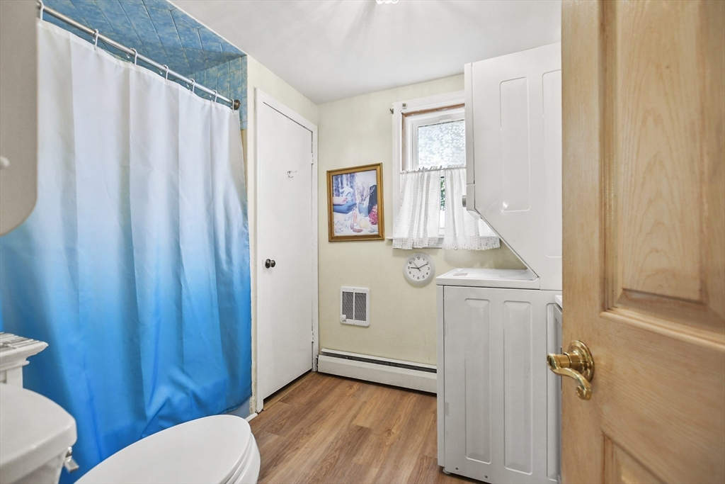 82 Cedar Street Everett, MA 02149 - Photo 15 of 41 a bathroom with a toilet a sink and curtain